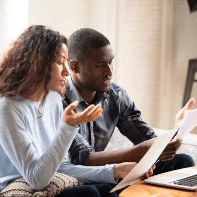 Couple reading documents for Kid Breukelen Realty Group