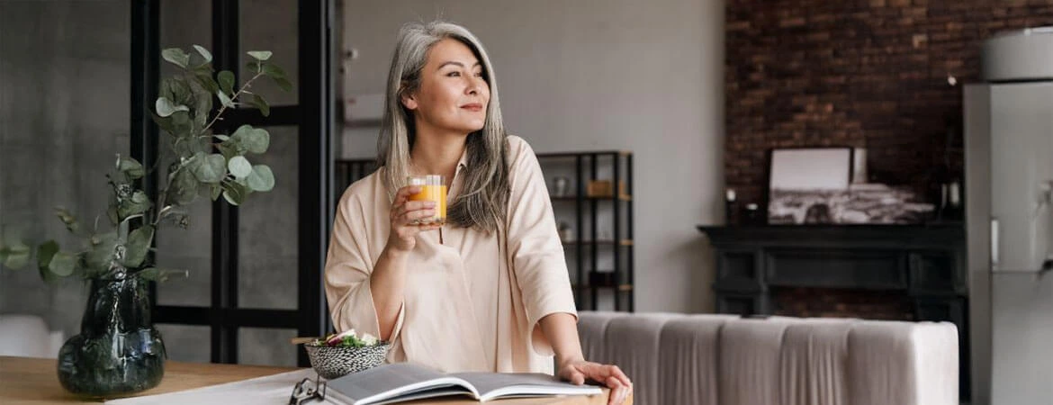 Woman Standing in Modern Living Room looking out. Learn about Probate Exemptions in our complete guide